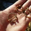 Set of 3 brass viking fibulas. Two types